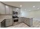 Renovated kitchen with stainless steel appliances and modern cabinetry at 8150 E Mitchell Dr, Scottsdale, AZ 85251