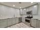 Modern kitchen featuring stainless steel appliances, gray cabinets, and granite counters at 8150 E Mitchell Dr, Scottsdale, AZ 85251