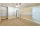Bedroom with neutral carpet, ceiling fan, and closet opens into a modern bathroom at 8150 E Mitchell Dr, Scottsdale, AZ 85251