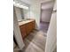 Bathroom featuring wood-look flooring, a wood vanity, and ample lighting at 8260 E Arabian Trl # 257, Scottsdale, AZ 85258