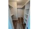 Walk-in closet with rods, shelves, and laminated hardwood flooring at 8260 E Arabian Trl # 257, Scottsdale, AZ 85258