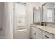 Bright bathroom featuring a shower-tub combo, a large mirror, and a granite sink at 8841 S 48Th St # 1, Phoenix, AZ 85044