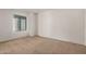 Empty bedroom features a neutral carpet, a large window and neutral walls at 8841 S 48Th St # 1, Phoenix, AZ 85044