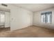 Spacious bedroom with neutral carpet, closet, neutral walls, and a window to let light in at 8841 S 48Th St # 1, Phoenix, AZ 85044