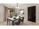 This dining room features a sleek table setting, art, and a modern light fixture for a bright, welcoming atmosphere at 8841 S 48Th St # 1, Phoenix, AZ 85044