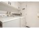 Bright laundry room with cabinets, washer and dryer, and an exterior exit door at 8841 S 48Th St # 1, Phoenix, AZ 85044