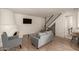 Spacious living room featuring a decorative fireplace, hardwood floors, and ample seating at 8841 S 48Th St # 1, Phoenix, AZ 85044