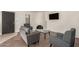 Comfortable living room featuring a stucco fireplace, hardwood floors, and neutral decor at 8841 S 48Th St # 1, Phoenix, AZ 85044