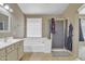 Bright Primary bathroom showcasing a soaking tub, shower and sink with neutral colors at 9609 E Monte Ave, Mesa, AZ 85209