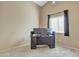 Neutral bedroom featuring two screens on a dark desk, with a large window providing natural light at 9609 E Monte Ave, Mesa, AZ 85209