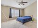 Carpeted bedroom filled with natural light, featuring a large window and a comfortable-looking bed at 9609 E Monte Ave, Mesa, AZ 85209