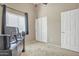 Bright bedroom showcasing a large window, closet, and door, creating a functional living space at 9609 E Monte Ave, Mesa, AZ 85209