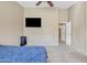 Carpeted bedroom with a bed, tv and a view of a hallway at 9609 E Monte Ave, Mesa, AZ 85209