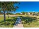 Scenic view of a neighborhood park complete with a playground and walking paths at 9609 E Monte Ave, Mesa, AZ 85209