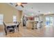 Inviting dining area with wood-look tile flooring, modern lighting, and stainless steel appliances at 9609 E Monte Ave, Mesa, AZ 85209