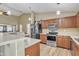 Open-concept kitchen featuring stainless steel appliances, ample countertops and open floorplan at 9609 E Monte Ave, Mesa, AZ 85209