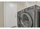 Laundry room featuring front load washer and dryer and a white entry door at 9609 E Monte Ave, Mesa, AZ 85209