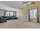 Spacious living room with plush carpet, large windows for natural light, and a comfortable blue couch at 9609 E Monte Ave, Mesa, AZ 85209
