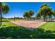 Well-maintained sand volleyball court for recreation in a lush green park setting at 9609 E Monte Ave, Mesa, AZ 85209