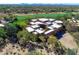 Aerial view of a luxury home with lush desert landscape and nearby golf course at 10040 E Happy Valley Rd # 449, Scottsdale, AZ 85255