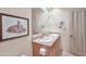 Bright bathroom with double sinks, light wood cabinets, and framed artwork at 10040 E Happy Valley Rd # 449, Scottsdale, AZ 85255