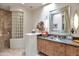 Unique bathroom featuring a walk-in shower with glass blocks, decorative mirror, and vessel sink at 10040 E Happy Valley Rd # 449, Scottsdale, AZ 85255