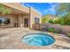 Inviting hot tub area with stone patio and desert landscaping at 10040 E Happy Valley Rd # 449, Scottsdale, AZ 85255