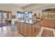 Well-lit kitchen showcasing an island, wood cabinets, stone floors, and a breakfast area with views at 10040 E Happy Valley Rd # 449, Scottsdale, AZ 85255