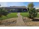 Lush backyard featuring artificial turf, mature palm trees, and elegant landscaping at 10236 W Westwind Dr, Peoria, AZ 85383