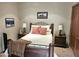 Bedroom featuring a wrought iron bed frame, and two side tables with lamps at 10236 W Westwind Dr, Peoria, AZ 85383