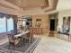 Formal dining room with chandelier, rug, curtains, and bar looking out to the living room at 10236 W Westwind Dr, Peoria, AZ 85383