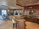 Open living area featuring a stone fireplace, ceiling fan, and a view to the granite countertop in the kitchen at 10236 W Westwind Dr, Peoria, AZ 85383