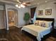 Elegant main bedroom featuring dark wood floors and open ensuite bathroom at 10236 W Westwind Dr, Peoria, AZ 85383