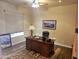 Office featuring a large desk, ceiling fan, and Southwestern rug underfoot at 10236 W Westwind Dr, Peoria, AZ 85383