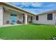 A covered patio opens to a backyard with artificial grass and comfortable outdoor seating at 10545 E Texas Ave, Mesa, AZ 85212