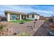 Wide angle of backyard with an outdoor seating area and desert landscaping at 10545 E Texas Ave, Mesa, AZ 85212