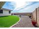 A backyard featuring artificial grass, gravel, and a brick wall is perfect for outdoor enjoyment at 10545 E Texas Ave, Mesa, AZ 85212