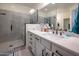 Modern bathroom featuring a glass-enclosed shower, vanity with sink and quartz countertops at 10545 E Texas Ave, Mesa, AZ 85212