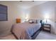 Cozy bedroom with a large bed, tile flooring, and ambient lighting at 10545 E Texas Ave, Mesa, AZ 85212