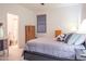 Bright bedroom with a large bed, ensuite bathroom, and dresser at 10545 E Texas Ave, Mesa, AZ 85212