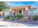 Inviting front porch features decorative brick accents and colorful potted plants for a cheerful welcome at 10545 E Texas Ave, Mesa, AZ 85212