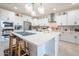 Bright kitchen with white cabinets, stainless appliances, and a central island with bar seating at 10545 E Texas Ave, Mesa, AZ 85212