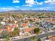 Scenic aerial view of a home with a pool nestled in a vibrant community near mountains at 10895 E Mission Ln, Scottsdale, AZ 85259