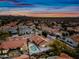 Beautiful sunset aerial view featuring a home with pool in a desert neighborhood at 10895 E Mission Ln, Scottsdale, AZ 85259