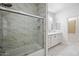 Bathroom featuring marble floors, a shower with glass doors, and a double sink vanity at 10895 E Mission Ln, Scottsdale, AZ 85259