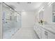 Bathroom featuring double vanity and a glass shower with marble tile at 10895 E Mission Ln, Scottsdale, AZ 85259