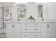 Bathroom vanity featuring double sinks, modern fixtures, and granite countertops at 10895 E Mission Ln, Scottsdale, AZ 85259