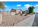 Charming home with desert landscaping, a terra cotta roof and a fenced side yard at 10895 E Mission Ln, Scottsdale, AZ 85259