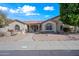 Charming home featuring a terra cotta roof, desert landscaping and covered entry at 10895 E Mission Ln, Scottsdale, AZ 85259