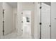 Bright hallway featuring marble floors and multiple doorways leading to various rooms of the house at 10895 E Mission Ln, Scottsdale, AZ 85259